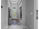 Bright entryway with neutral walls, a decorative rug, and a coat rack with bench at 5742 Stockport St, Riverview, FL 33578