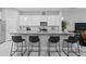 Bright kitchen with white cabinets, an island with seating, and stainless steel appliances at 5742 Stockport St, Riverview, FL 33578
