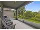Covered lanai featuring outdoor seating and a screened in opening to view a large green backyard at 5742 Stockport St, Riverview, FL 33578