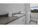Laundry room with granite counters, a sink, and modern washer and dryer units at 5742 Stockport St, Riverview, FL 33578