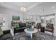 Open-concept living room with stylish furniture, a dining area, and a view into the kitchen at 5742 Stockport St, Riverview, FL 33578