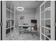 Bright office with double glass doors, desk, chair, a TV, and exercise equipment at 5742 Stockport St, Riverview, FL 33578