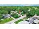 An aerial view of a single-Gathering home showcasing the surrounding mature trees and neighborhood at 6011 Tangerine S Ave, Gulfport, FL 33707