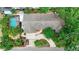 The aerial shot highlights the home's layout, lush landscaping, and screened-in pool at 6011 Tangerine S Ave, Gulfport, FL 33707