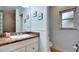 Bathroom boasts a clean vanity, framed mirror and decorative wainscoting at 6011 Tangerine S Ave, Gulfport, FL 33707