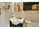 Simple bathroom with a dark vanity, shower, and toilet in a bright white room at 6011 Tangerine S Ave, Gulfport, FL 33707