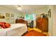 Relaxing bedroom features a window, wood floors, and light green walls at 6011 Tangerine S Ave, Gulfport, FL 33707