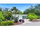 Charming single-story home with a one-car garage, surrounded by mature trees and tropical plants at 6011 Tangerine S Ave, Gulfport, FL 33707