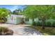 Charming home showcasing a lush front yard, with a long drive-way and an attached one-car garage at 6011 Tangerine S Ave, Gulfport, FL 33707