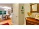 Hallway leads to dining room with hardwood floors and charming decor including colorful artwork and wooden accents at 6011 Tangerine S Ave, Gulfport, FL 33707
