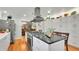 Modern kitchen featuring sleek appliances, a center island with a gas cooktop, and hardwood flooring at 6011 Tangerine S Ave, Gulfport, FL 33707