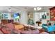 Inviting living room with hardwood floors, plush seating, and an open view of the kitchen and dining area at 6011 Tangerine S Ave, Gulfport, FL 33707