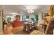 Open-concept living room and dining room area with hardwood floors, chandelier lighting, and ample seating at 6011 Tangerine S Ave, Gulfport, FL 33707