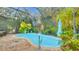 The refreshing pool is surrounded by verdant tropical plants and a screened enclosure at 6011 Tangerine S Ave, Gulfport, FL 33707