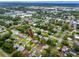 Wide aerial view of a neighborhood with tree coverage, with the highlighted home centered at 614 12Th Nw St, Largo, FL 33770