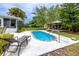 Relaxing backyard with a private pool, lounge chairs, and a gazebo at 614 12Th Nw St, Largo, FL 33770