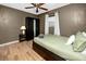 Bedroom with a ceiling fan, laminate wood floors, closet, and a sleek, modern design at 614 12Th Nw St, Largo, FL 33770