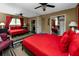 Bright bedroom with red bedding, stylish black furniture, and large mirrored wall reflecting the space at 614 12Th Nw St, Largo, FL 33770