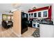 A well-lit kitchen with white cabinets and a black refrigerator at 614 12Th Nw St, Largo, FL 33770