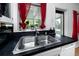 Close up of a dual stainless kitchen sink overlooking the back yard at 614 12Th Nw St, Largo, FL 33770