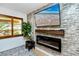 A modern electric fireplace situated below a TV, along with a textured wall and natural light at 614 12Th Nw St, Largo, FL 33770