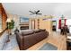 Comfortable living room features hardwood floors, brick accent wall and modern ceiling fan at 614 12Th Nw St, Largo, FL 33770
