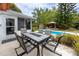 Outdoor dining area next to pool and lush landscaping, ideal for summer entertaining at 614 12Th Nw St, Largo, FL 33770