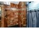 Detailed view of a glass enclosed shower featuring a rainfall shower head and modern fixtures at 614 12Th Nw St, Largo, FL 33770