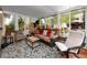 Bright sunroom featuring comfortable seating, a stylish rug, and lots of natural light at 614 12Th Nw St, Largo, FL 33770