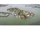 Aerial view of the neighborhood with waterfront property on a beautiful day at 6913 Grande Vista S Way, St Petersburg, FL 33707