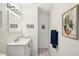 Well lit bathroom features black and white tile floor, and modern vanity at 6913 Grande Vista S Way, St Petersburg, FL 33707