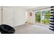 Minimalist bedroom with a sliding glass door leading to the backyard at 6913 Grande Vista S Way, St Petersburg, FL 33707