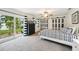 Bright bedroom with a patterned bedspread, dresser, and sliding glass doors to the outdoors at 6913 Grande Vista S Way, St Petersburg, FL 33707