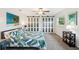 This is a spacious bedroom with a ceiling fan, a large bed, and sliding closet doors at 6913 Grande Vista S Way, St Petersburg, FL 33707