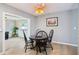 Bright dining room with view to living room, ceiling fan and new flooring at 6913 Grande Vista S Way, St Petersburg, FL 33707