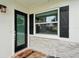Welcoming front door with black frame, stone facade, and a cheerful welcome mat at 6913 Grande Vista S Way, St Petersburg, FL 33707