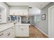 Bright kitchen features white cabinets, stainless steel hardware, and wood-look flooring at 6913 Grande Vista S Way, St Petersburg, FL 33707
