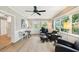 Inviting living room featuring comfortable seating, a ceiling fan, and natural light at 6913 Grande Vista S Way, St Petersburg, FL 33707