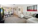 Inviting living room with a comfortable sectional sofa, neutral carpet, and stylish decor at 6913 Grande Vista S Way, St Petersburg, FL 33707