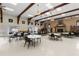Large community center room with tables, chairs, a fireplace, and a library at 7118 El Meyers St, Zephyrhills, FL 33541
