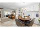 Cozy dining area adjacent to the living room with a chandelier and wood table at 7118 El Meyers St, Zephyrhills, FL 33541