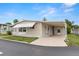 Well-kept single-story home with covered parking, a white door, and established landscaping at 7118 El Meyers St, Zephyrhills, FL 33541