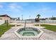 Community hot tub with wooden deck surround, benches, and pool in background at 7118 El Meyers St, Zephyrhills, FL 33541