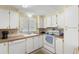 Bright kitchen with white cabinets, wood countertops, and appliances at 7118 El Meyers St, Zephyrhills, FL 33541