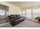 The lanai includes natural light and cozy furniture at 7118 El Meyers St, Zephyrhills, FL 33541