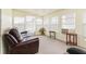 Cozy lanai provides extra living space with comfortable furniture and plenty of natural light at 7118 El Meyers St, Zephyrhills, FL 33541