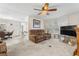 The living room includes neutral carpet, a comfortable sofa, and plenty of natural light at 7118 El Meyers St, Zephyrhills, FL 33541