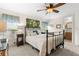Relaxing bedroom features natural light and a view of the ensuite bathroom at 7118 El Meyers St, Zephyrhills, FL 33541