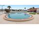 Community pool featuring clear blue water, surrounding patio with lounge chairs, and nearby clubhouse at 7118 El Meyers St, Zephyrhills, FL 33541