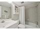 Cozy bathroom with tiled shower, updated sink, and storage cabinet at 7304 W Country Club N Dr # 113, Sarasota, FL 34243